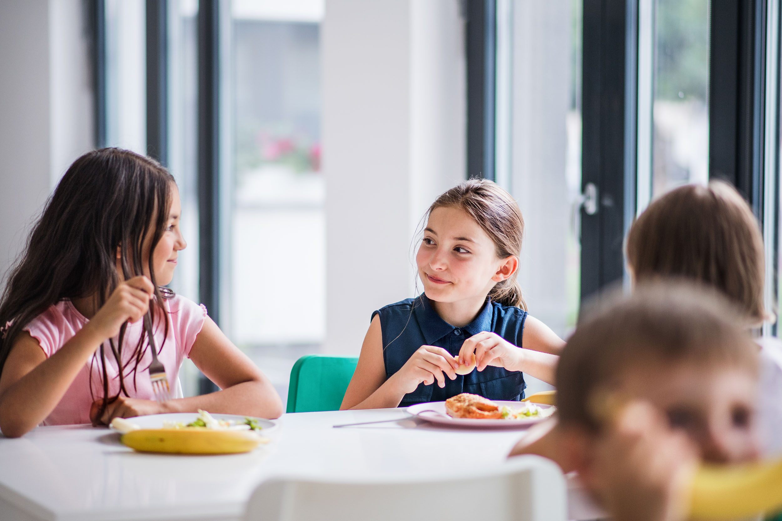 Teenage Students Being Served Meal In School Canteen