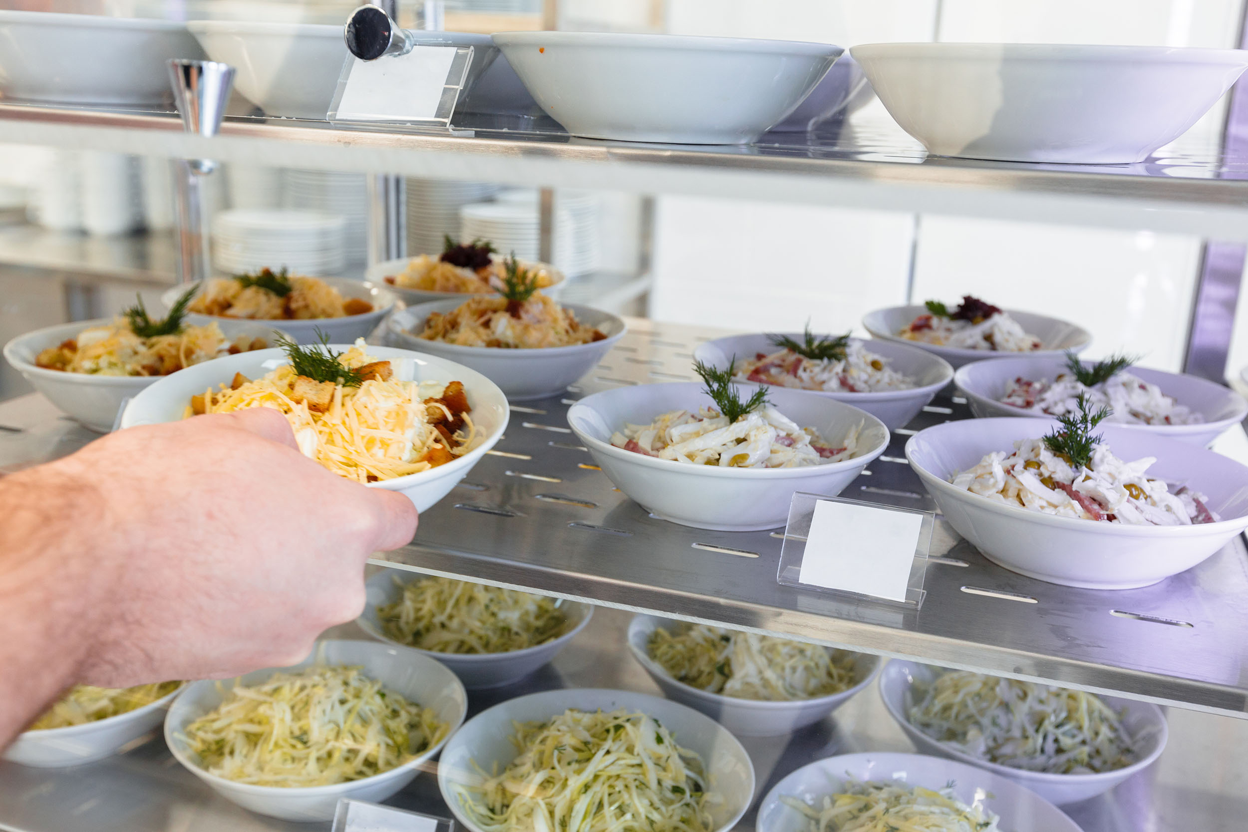 Teenage Students Being Served Meal In School Canteen