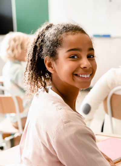African-american young smart schoolgirl pupil attending school lesson class listening to teacher African-american young smart schoolgirl pupil student attending school lesson class listening to the teacher. Back to school. New academic year semester.